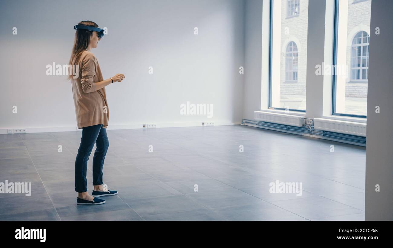 Young Hipster Woman in Holographic Augmented Reality Glasses Standing ...