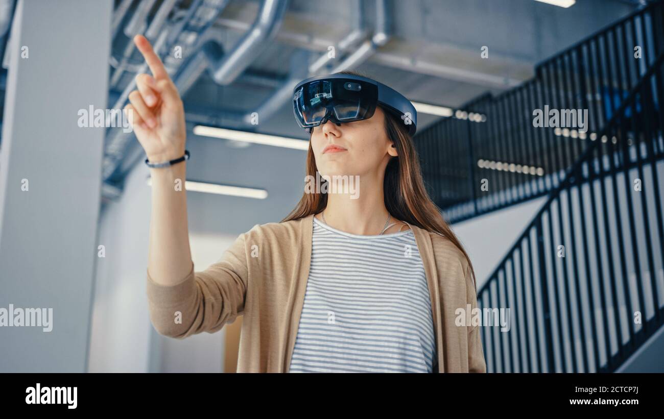 Young Hipster Woman in Holographic Augmented Reality Glasses Standing ...