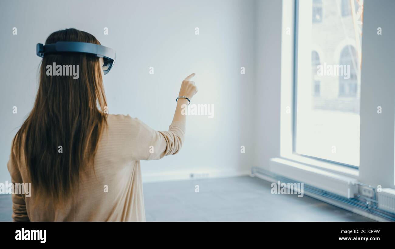 Young Hipster Woman in Holographic Augmented Reality Glasses Standing ...