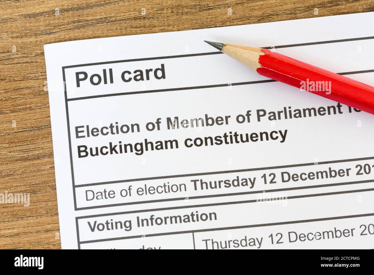 Poll card for a UK general election, voting information paper on desk with pencil Stock Photo