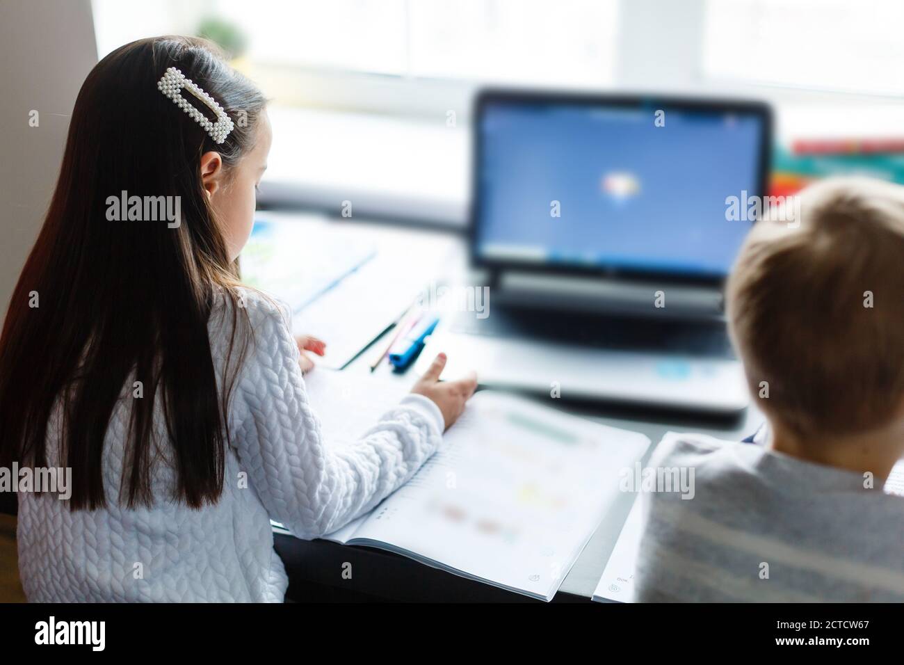 Distance learning online education. Schoolboy and girl studying at home ...