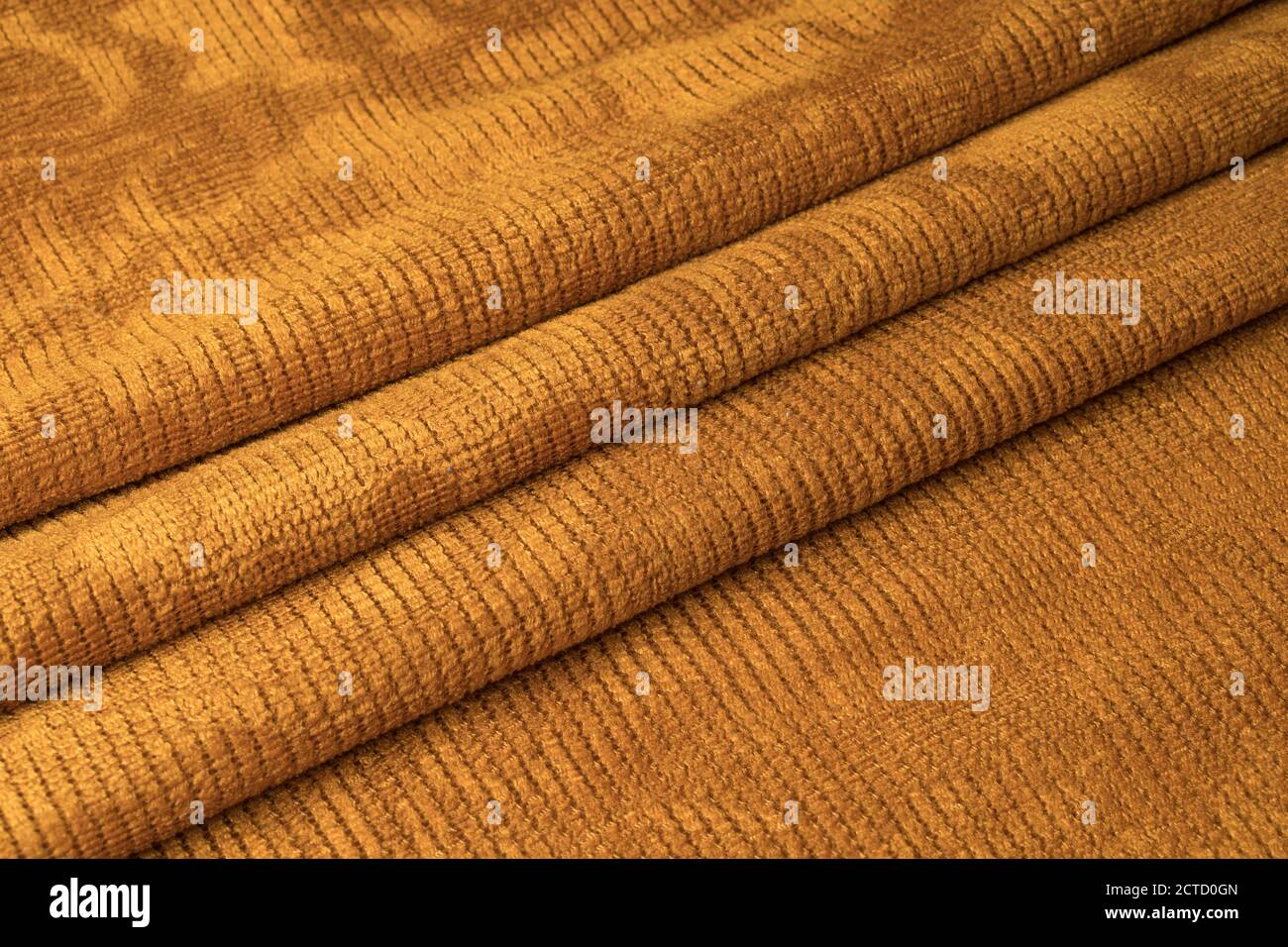 Orange pleated fabric in the middle Stock Photo