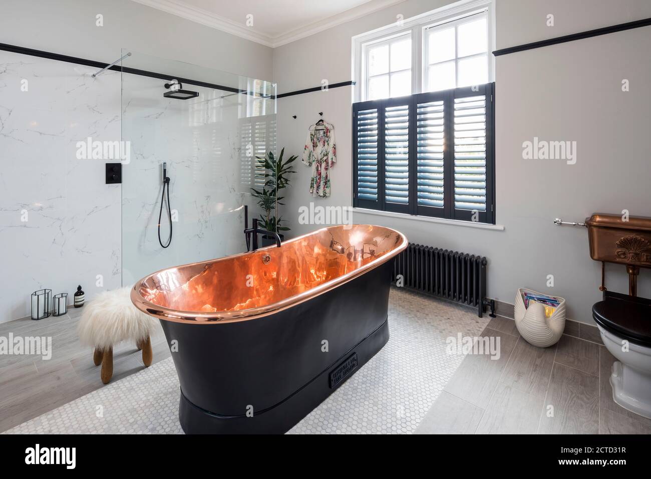 Black, copper-lined, freestanding bath in the bathroom of a Victorian ...