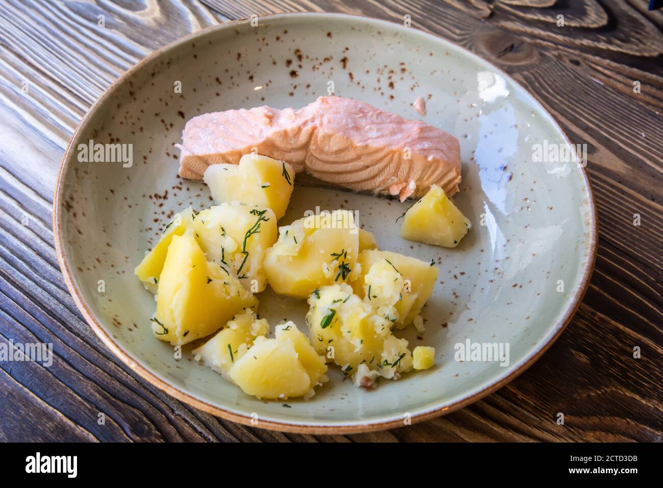 Plate of salmon with boiled potatoes, in Saint Petersburg, Russia. Stock Photo