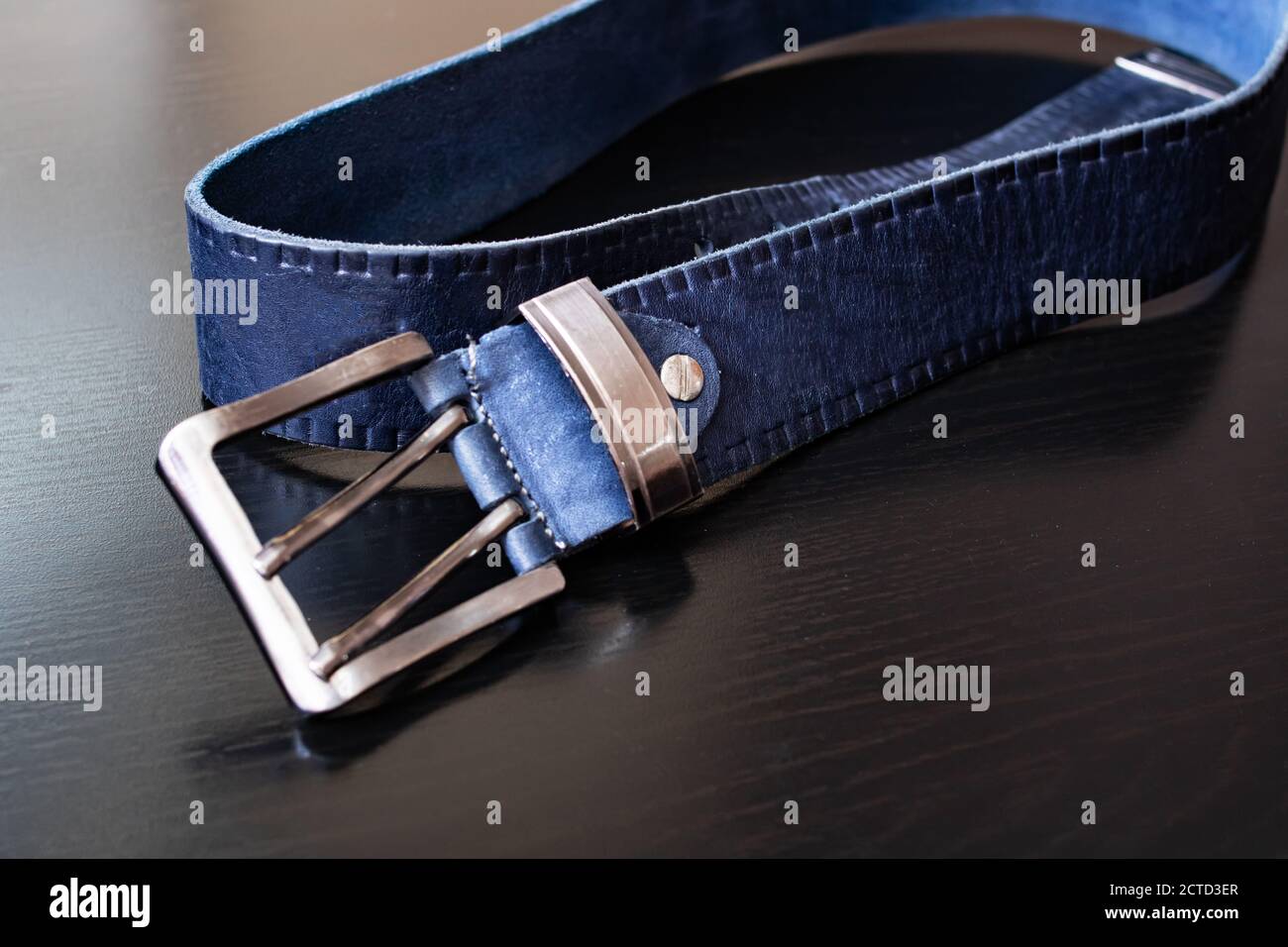 Blue belt buckle on a wooden table 