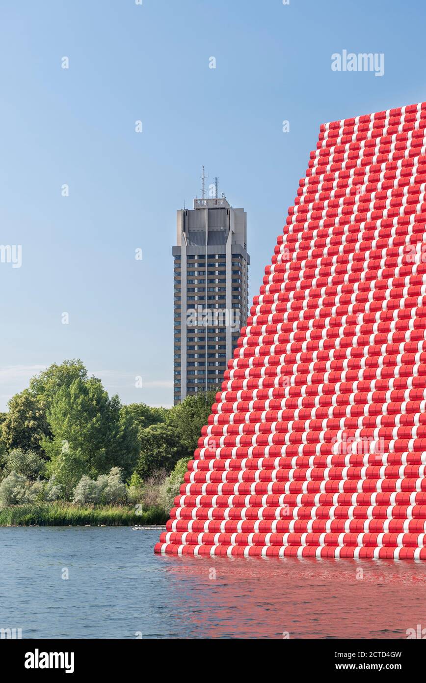 The London Mastaba by Christo and Jeanne-Claude is a temporary sculpture in Hyde Park comprised of horizontally stacked barrels on a floating platform in Serpentine Lake. Installed for the summer 2018 in London, UK. Stock Photo