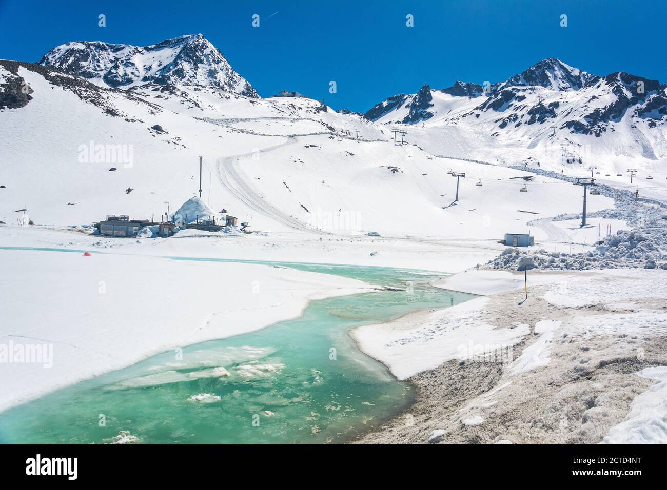 Snowy mountainous landscape around Eisgrat mountain station at Stubai Glacier area in Tyrol, Austria, with frozen creek. Stock Photo