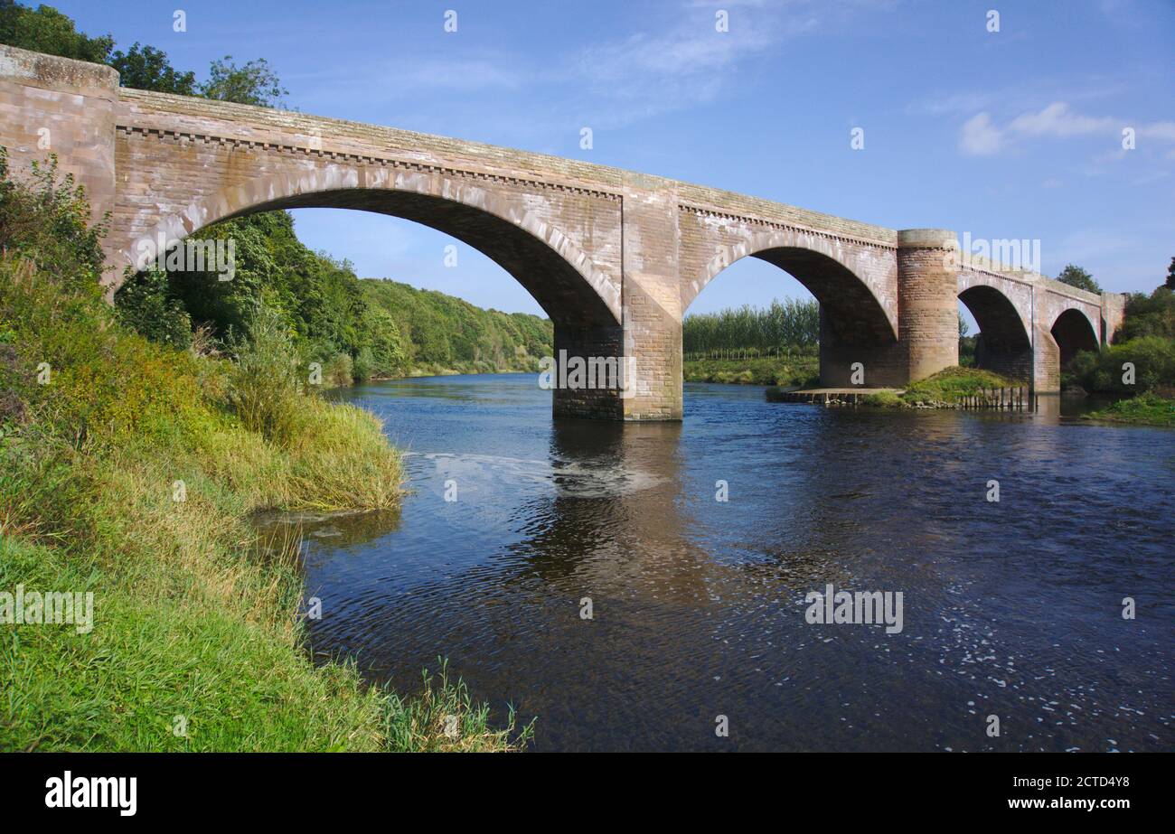 19th century four-span Ladykirk and Norham Bridge crossing the River Tweed, joining Berwickshire, Scottish Borders (left) and Northumberland (right). Stock Photo