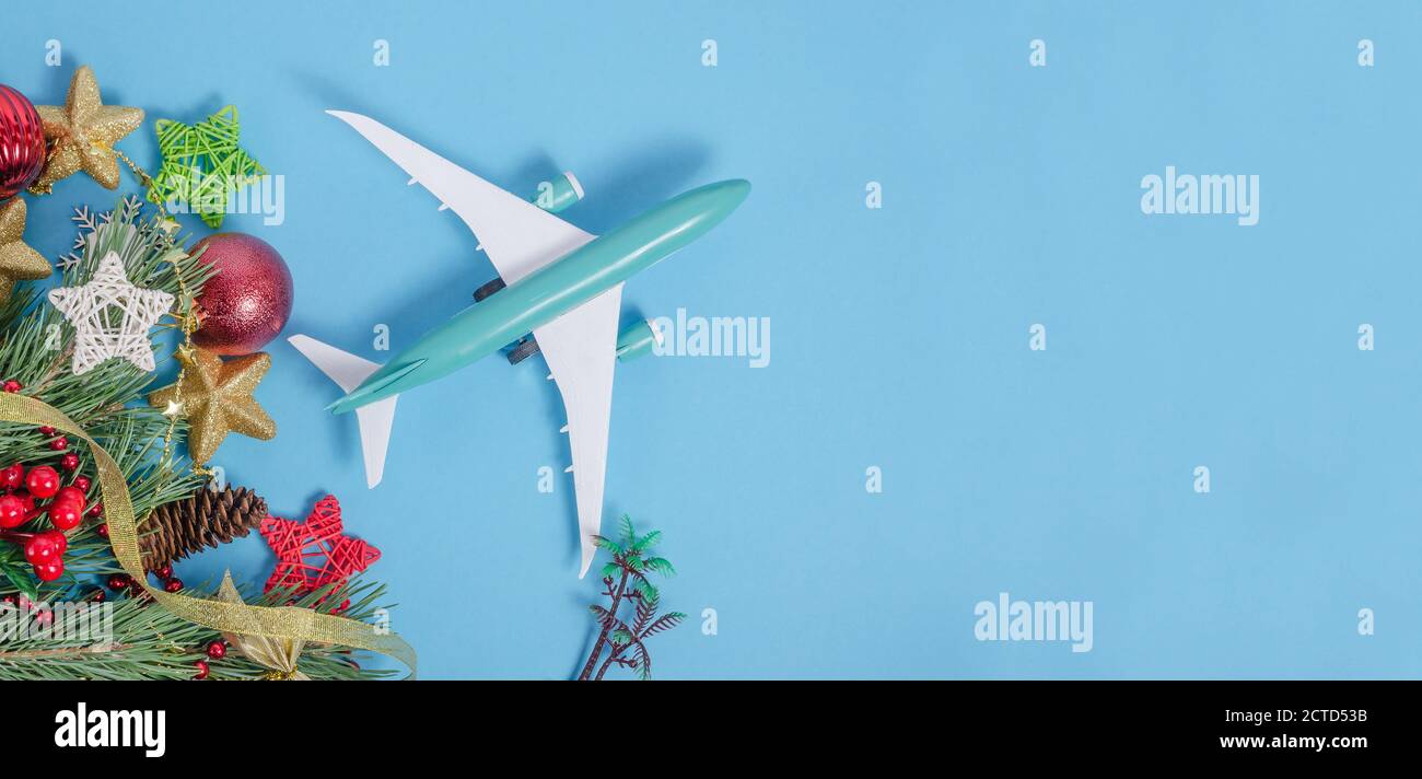 Blue background banner for travel agencies with airplane and Christmas decor with copy space Stock Photo