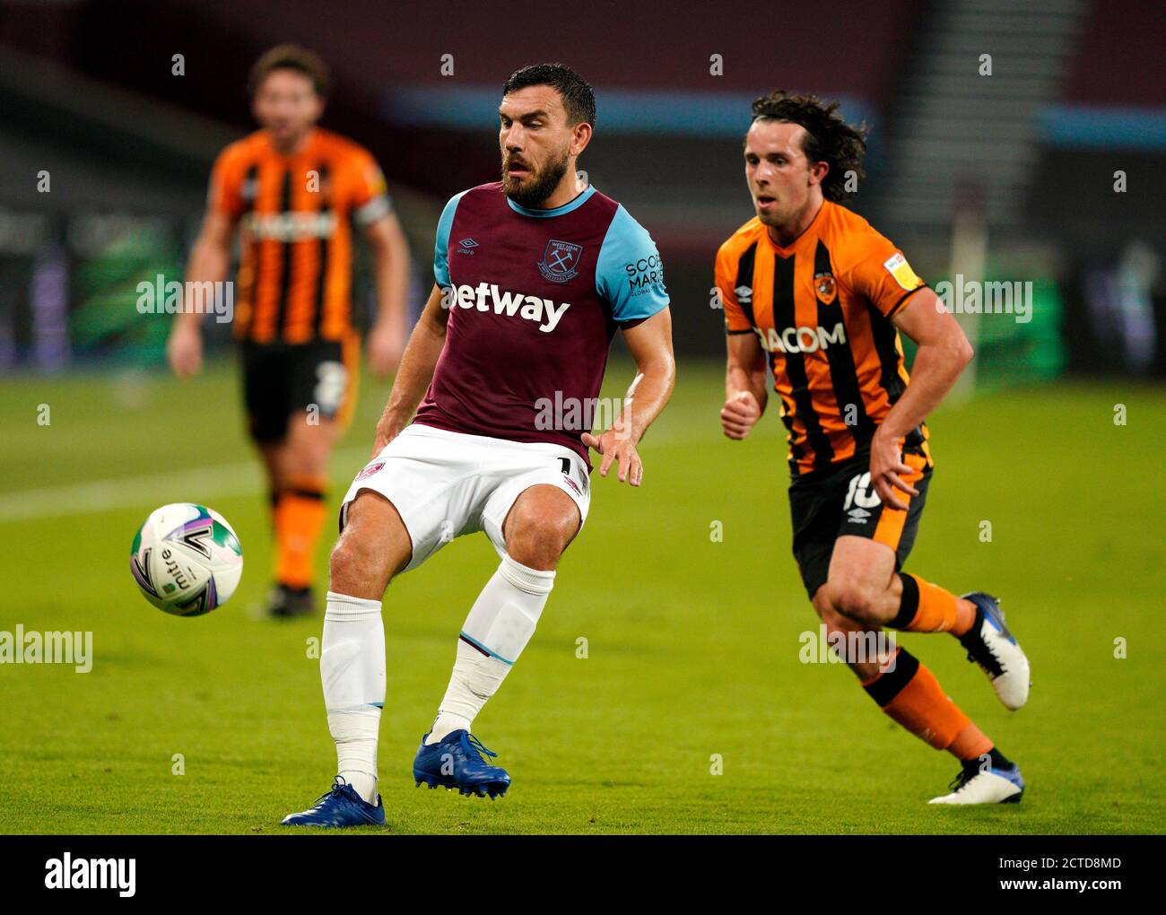 West Ham United's Robert Snodgrass (left) and Hull City's George Honeyman battle for the ball during the Carabao Cup third round match at the London Stadium. Stock Photo