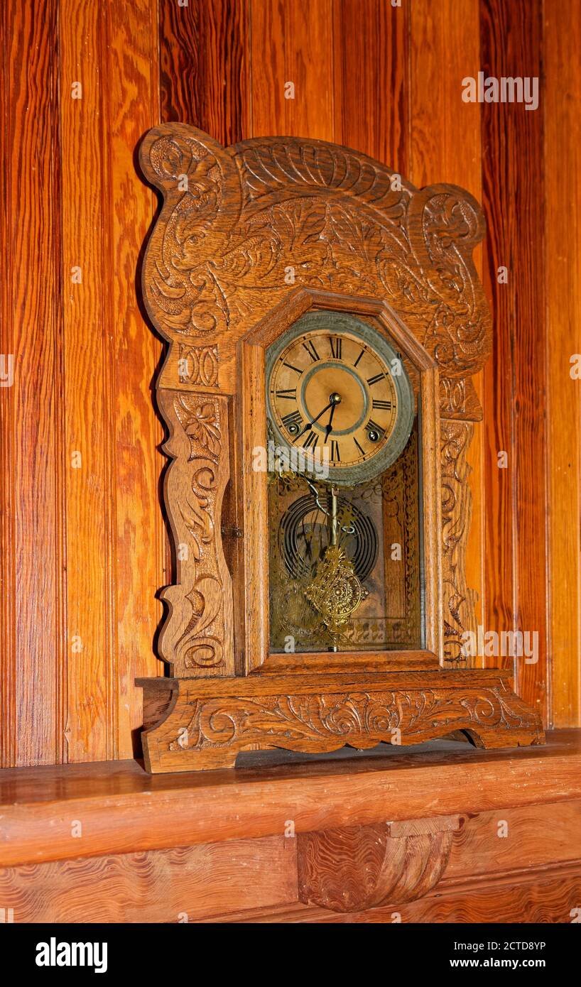 antique clock, pendulum, carved wood cabinet, ornate, wood wall, timepiece,  Historic Spanish Point, Florida, Osprey, FL Stock Photo - Alamy