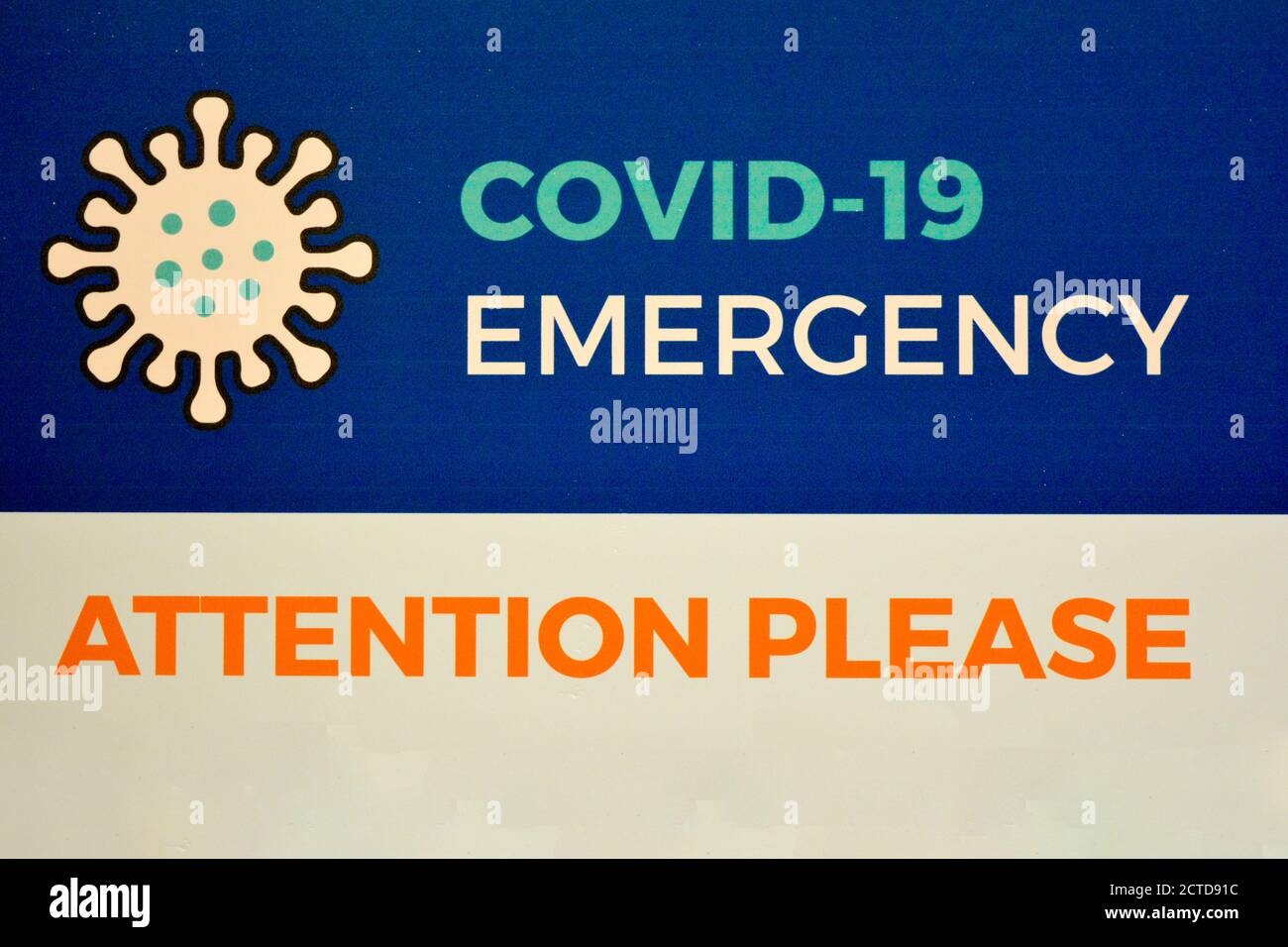 A warning sign 'COVID-19 Emergency. Attention please', written in english language, advises to be careful to coronavirus and the possible second wave Stock Photo