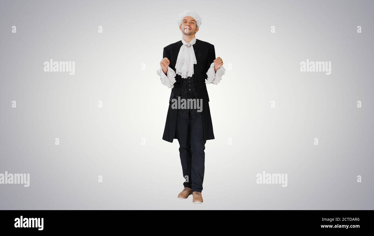Man in old-fashioned frock coat and white wig talking and waivin Stock Photo