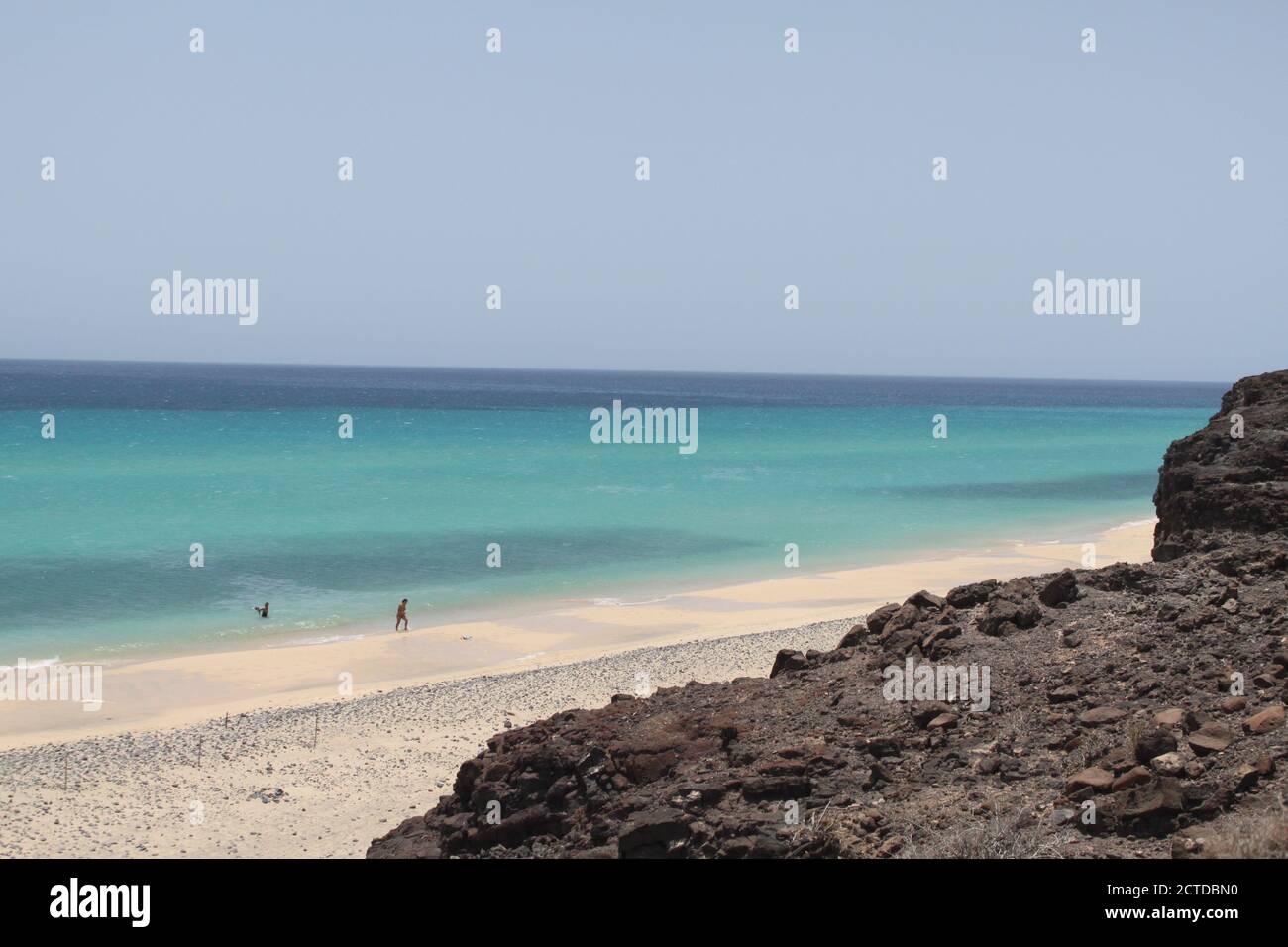 A group of tourists on the Mal Nombre beach, on the Canary Island of Fuerteventura, enjoy their holidays in July 2020. /ANA BORNAY Stock Photo