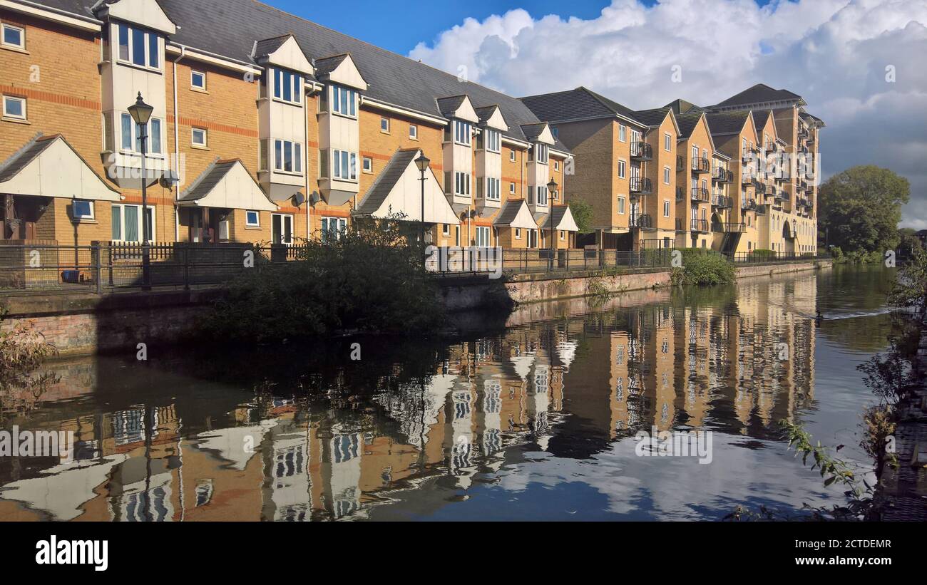New buildings reflected against the still waters of the Kennet in Reading, Berkshire Stock Photo