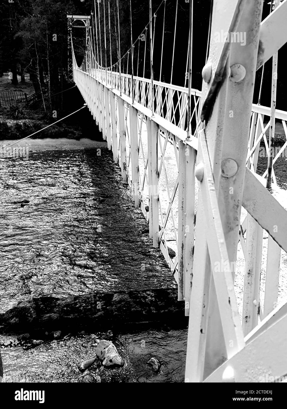 a historic white bridge in scotland,UK made of metal, black and white Stock Photo