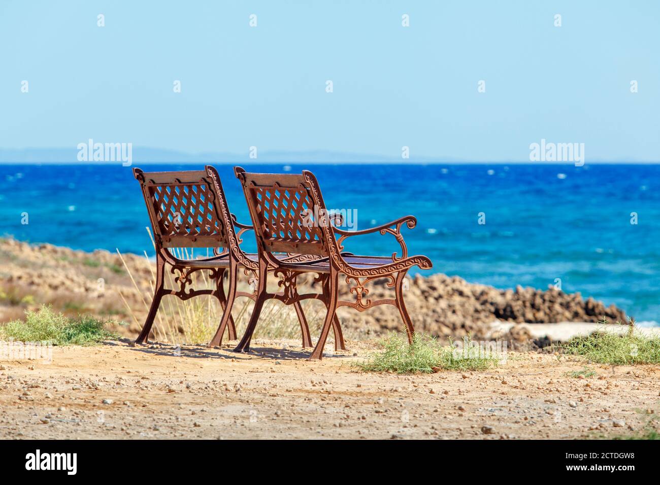 Two beautiful brown chair standing on the sea shore. Cyprus Stock Photo