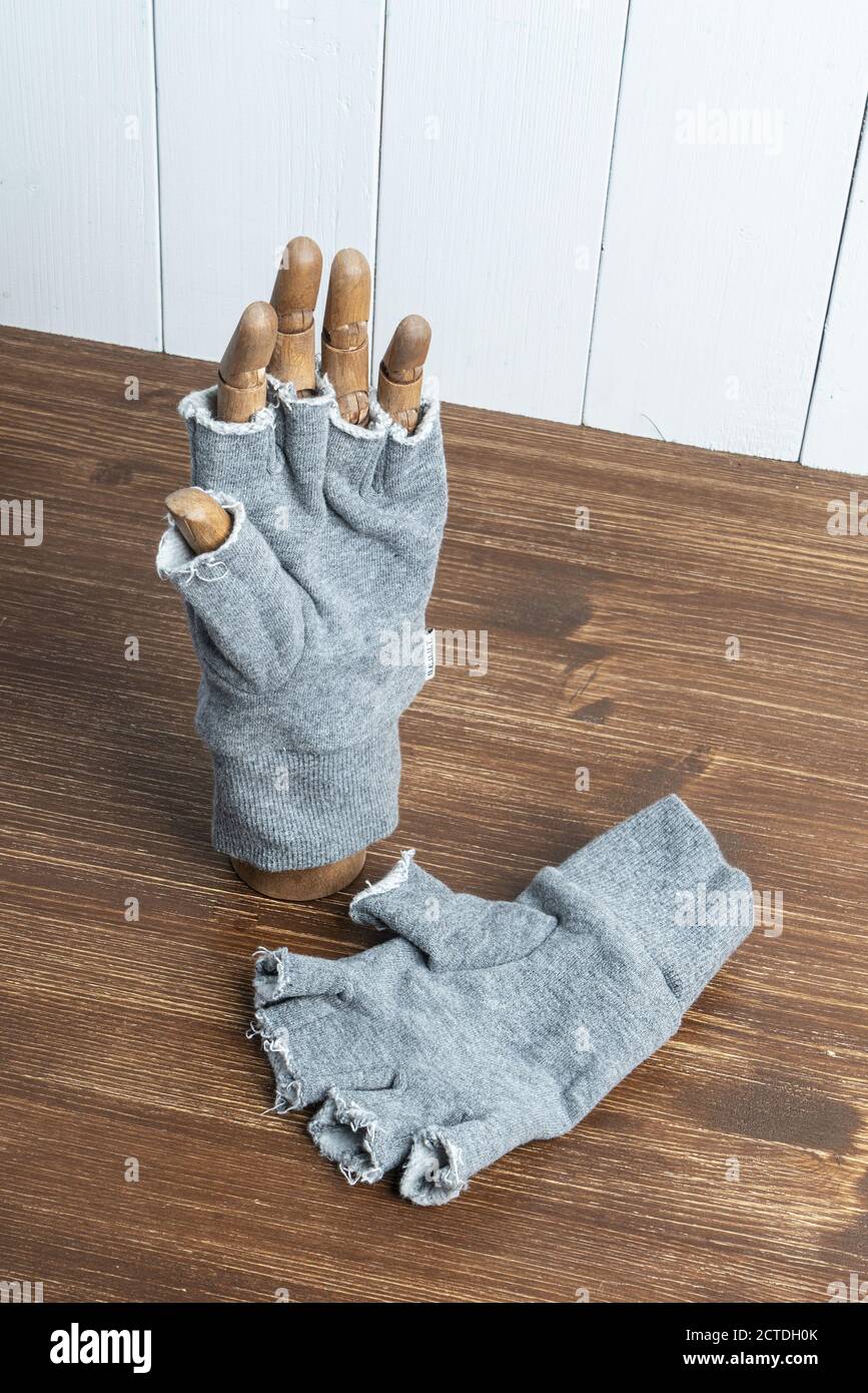 worn on a wooden hand on a table Stock Photo