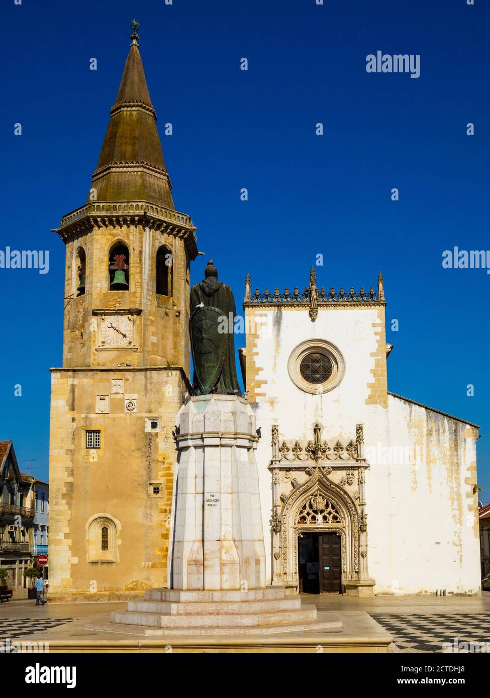The octagonal bell tower of Saint John the Baptist church and Christ Order knight D.Gualdim Pais statue on Republic Square in old town. Tomar Portugal Stock Photo