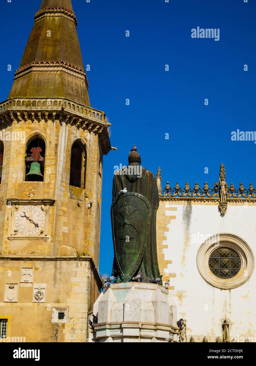 The octagonal bell tower of Saint John the Baptist church and Christ Order knight D.Gualdim Pais statue on Republic Square in old town. Tomar Portugal Stock Photo