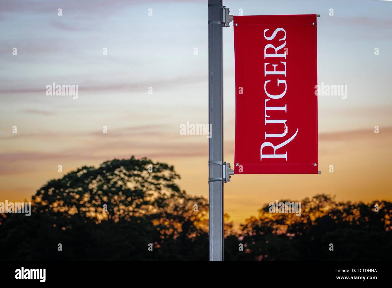 Rutgers University logo on banner against colorful skies Stock Photo