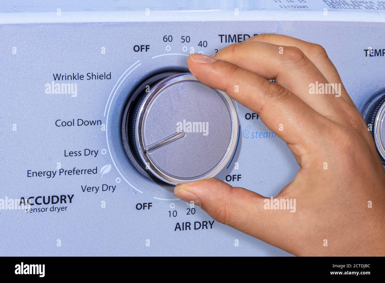 Calgary, Alberta, Canada. Sep 22, 2020.A person drying laundry with a Whirlpool high-efficiency electric dryer that reduce energy consumption. Stock Photo