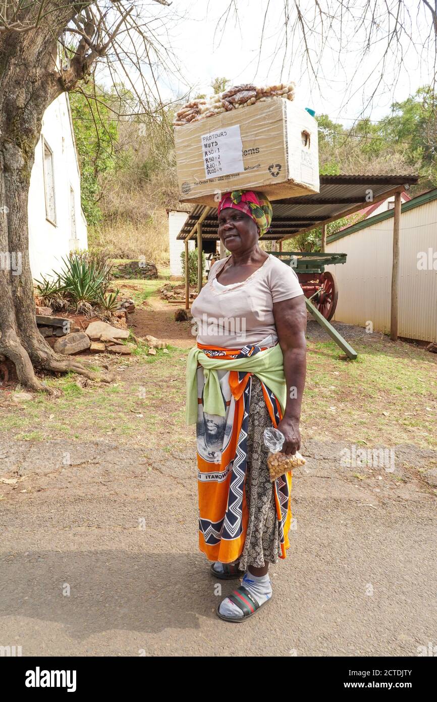 African street vendor portrait with a box of nuts on her head in Pilgrims Rest, South Africa Stock Photo