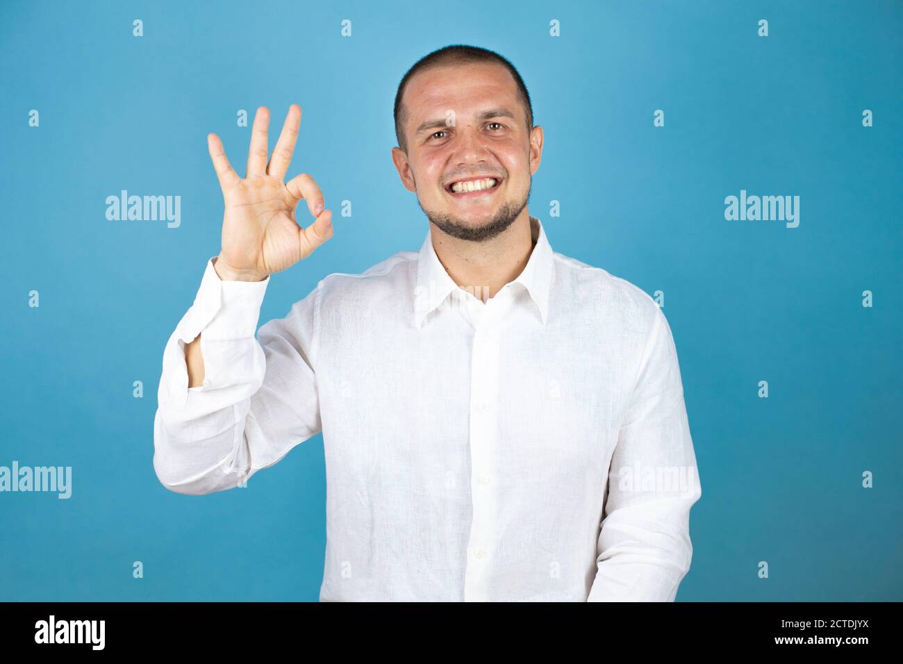 Russian business man wearing white shirt standing over blue background ...