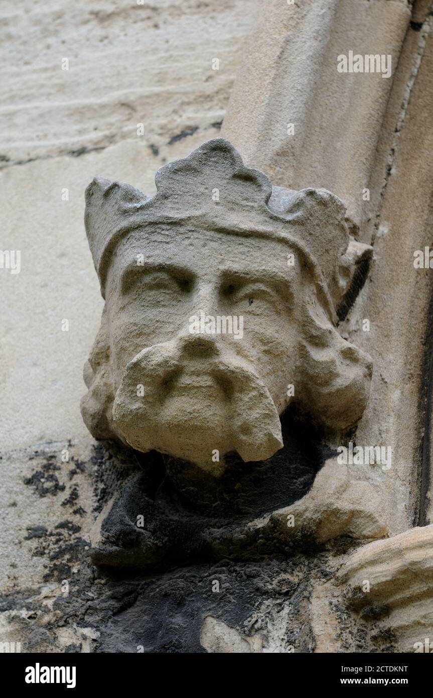 Stone carving of a head on the south doorway of the nave of St Augustine's Church, Hedon, East Yorkshire, England Stock Photo