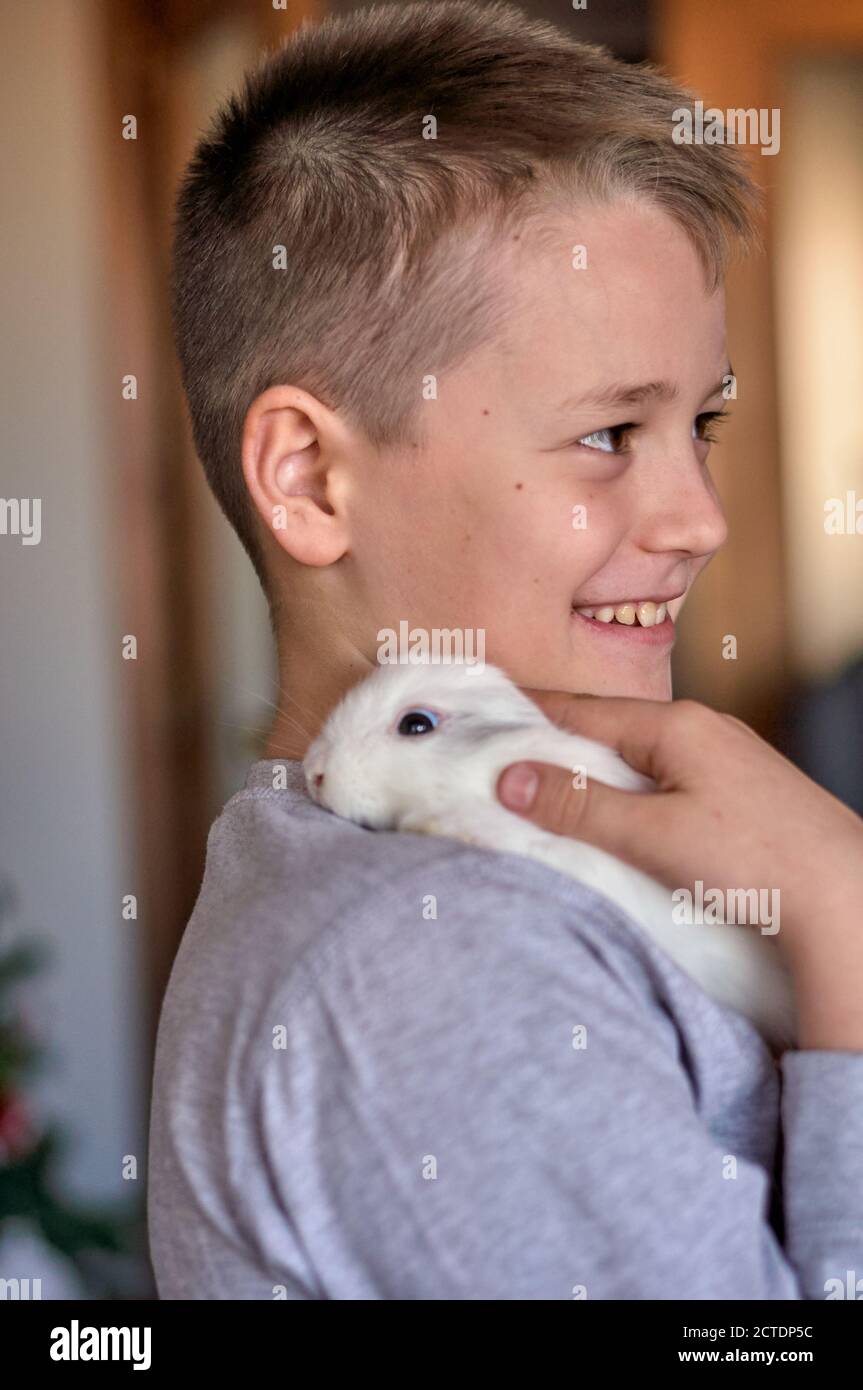 a boy with a white rabbit in his hands Stock Photo - Alamy