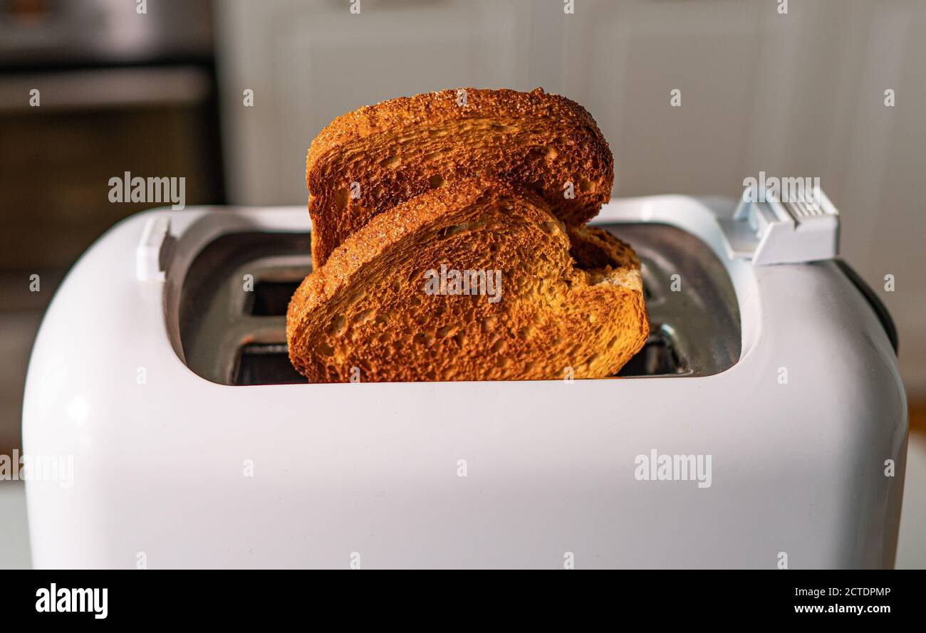 Two roasted toast bread popping up of toaster Stock Photo Alamy