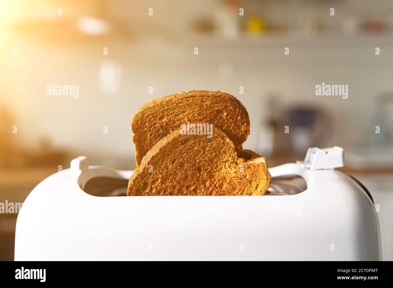 Two roasted toast bread popping up of toaster Stock Photo Alamy