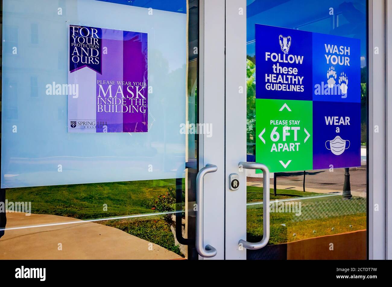 Signs remind students to practice social distancing, wash their hands, and wear a mask to prevent COVID-19 at Spring Hill College in Mobile, Alabama. Stock Photo