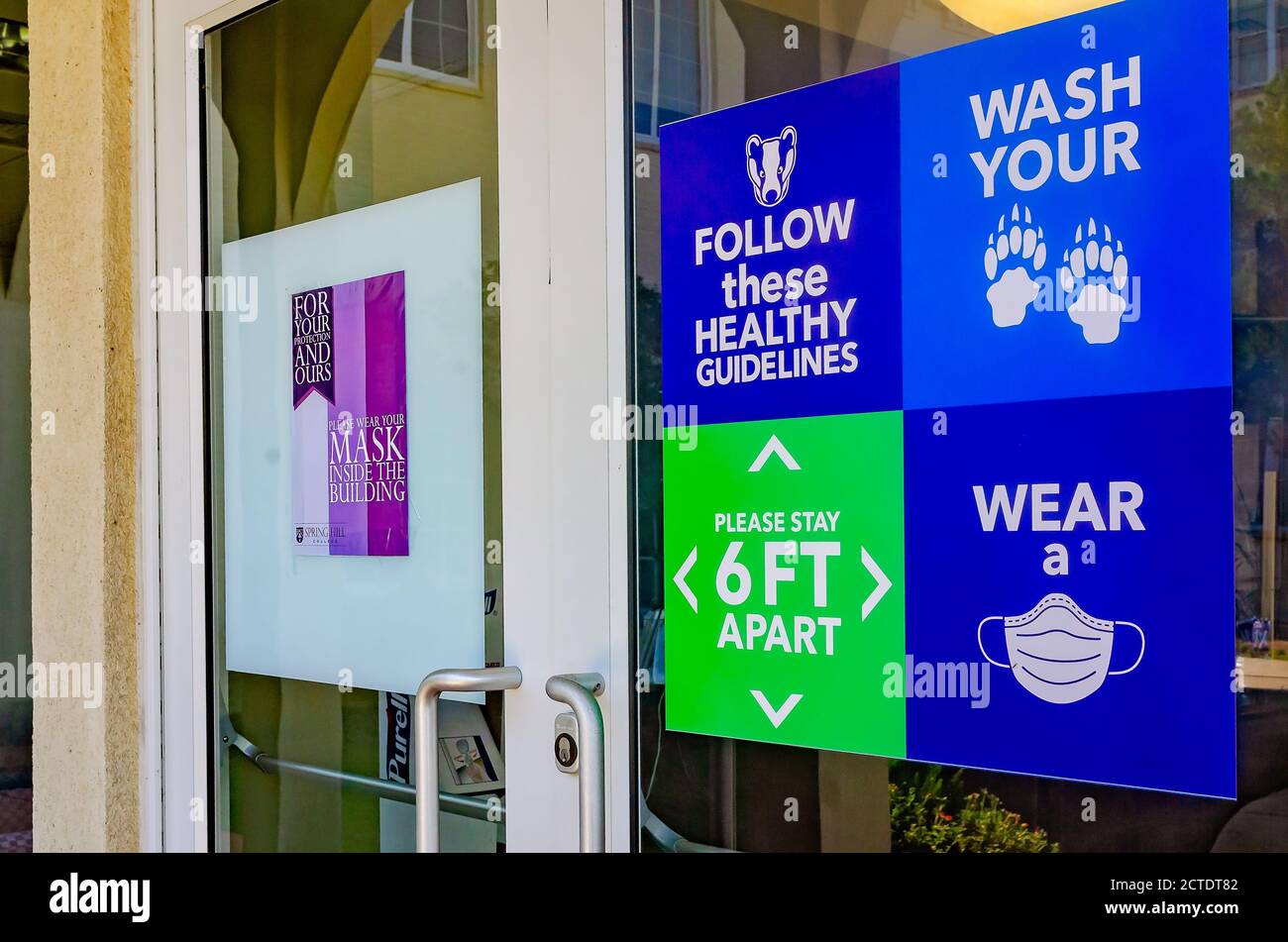 Signs remind students to practice social distancing, wash their hands, and wear a mask to prevent COVID-19 at Spring Hill College in Mobile, Alabama. Stock Photo