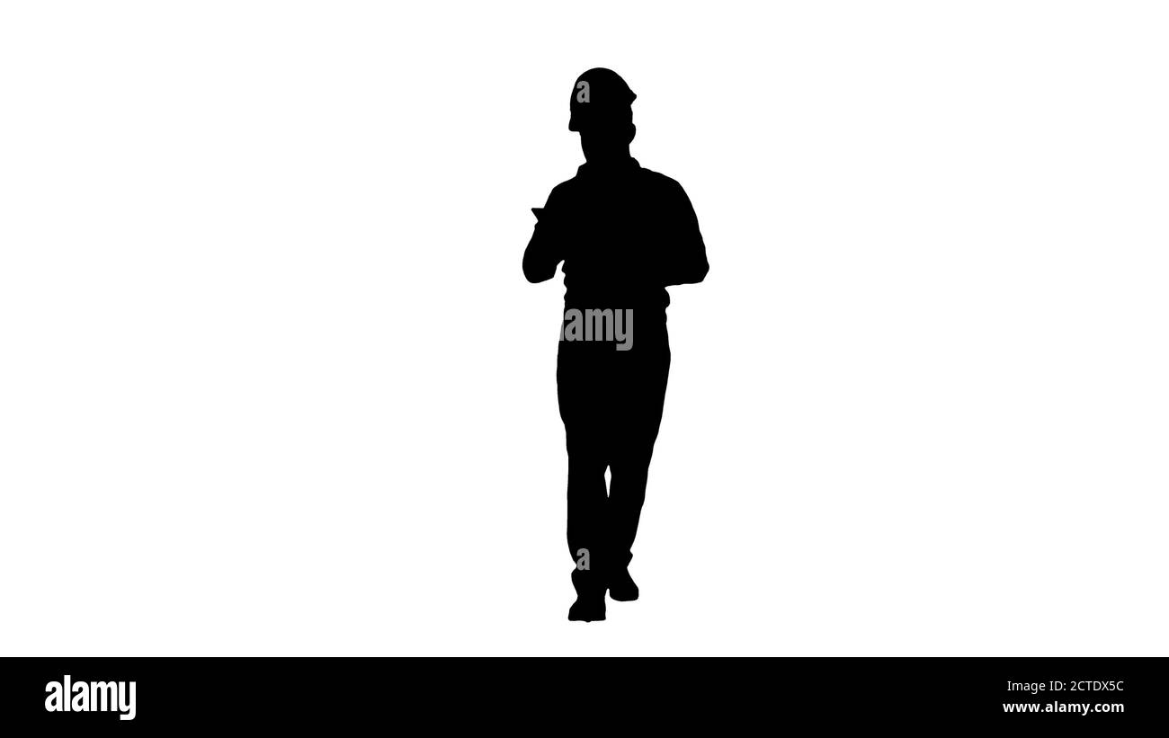 Engineer walking and using smartphone, Alpha Channel Stock Photo