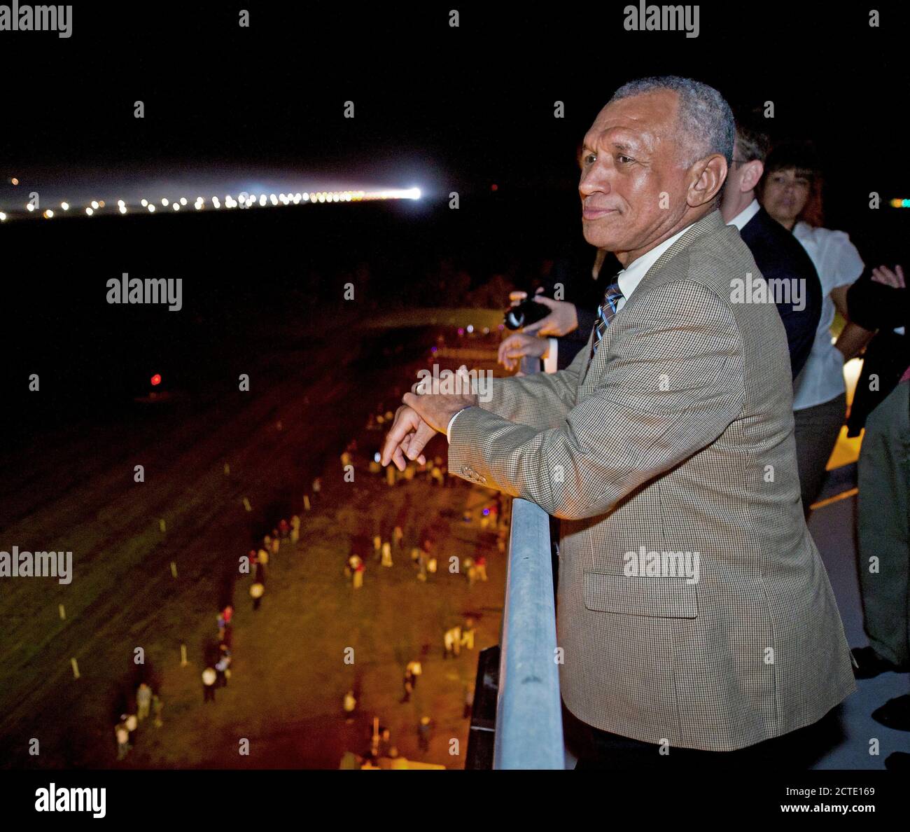 NASA Administrator Charles Bolden looks at the Space Shuttle Endeavour (STS-134) from the air traffic control tower at the Shuttle Landing Facility (SLF) shortly after Endeavour made its final landing at the Kennedy Space Center, Wednesday, June 1, 2011, in Cape Canaveral, Fla. Endeavour, after completing a 16-day mission to outfit the International Space Station, spent 299 days in space and traveled more than 122.8 million miles during its 25 flights. It launched on its first mission on May 7, 1992. Stock Photo