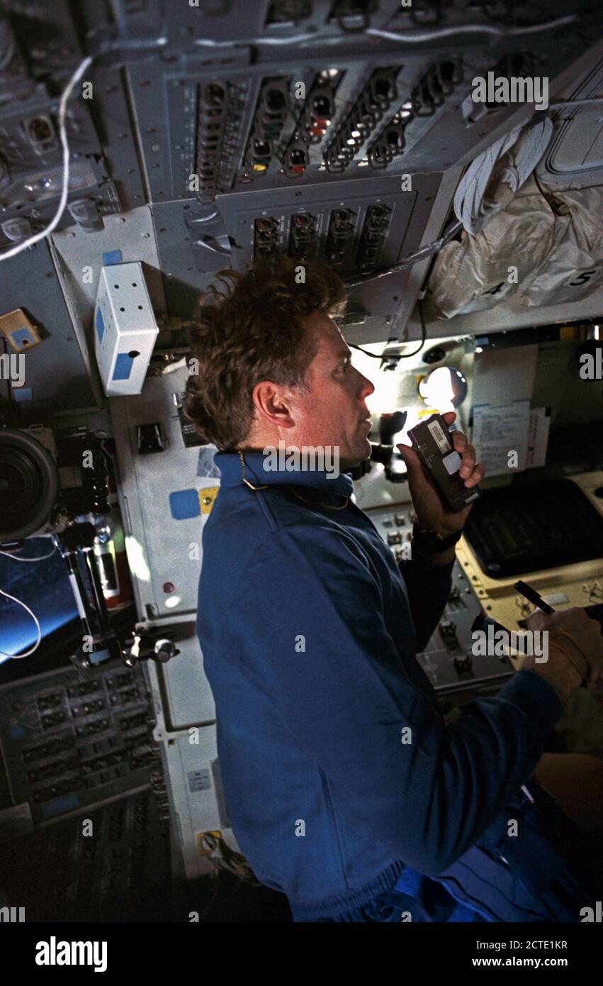 (2 April 1992) --- STS-45 Payload Specialist Byron Lichtenberg talks into a cassette tape recorder to note observations following a science run of the Atmospheric Emissions Photometric Imaging (AEPI) experiment. Lichtenberg is on the aft flight deck of Atlantis, Orbiter Vehicle (OV) 104. At Lichtenberg's left is the mission station, the forward flight deck and window W6 appear behind him, and overhead control panels appear above his head. Stock Photo
