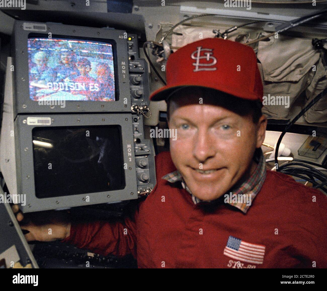 (25 June-9 July 1992) --- Astronaut Richard Richards, STS-50 mission commander, stands by a monitor displaying a group of elementary pupils (Addison Elementary School, Marietta Georgia) who were among the many students and others on Earth who communicated with members aboard the Earth-orbiting Space Shuttle Columbia. Stock Photo