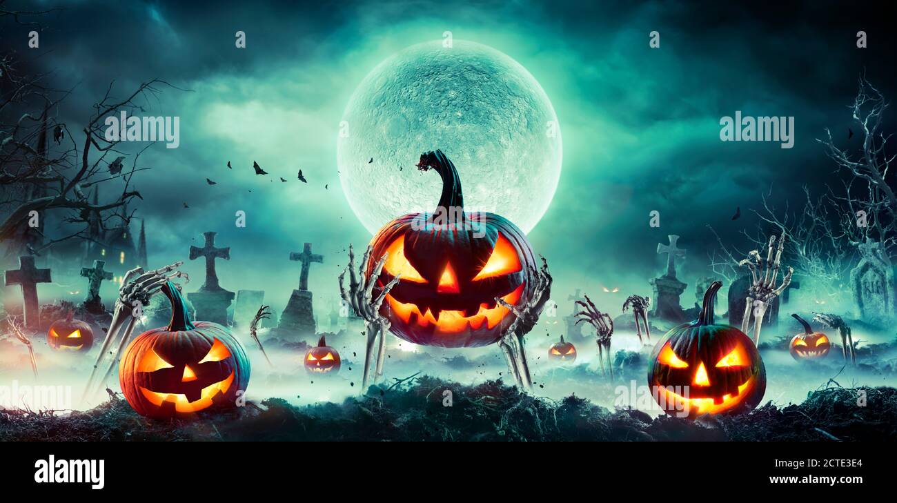 Jack O’ Lantern On Skeleton Arms In Graveyard At Night - Halloween With ...