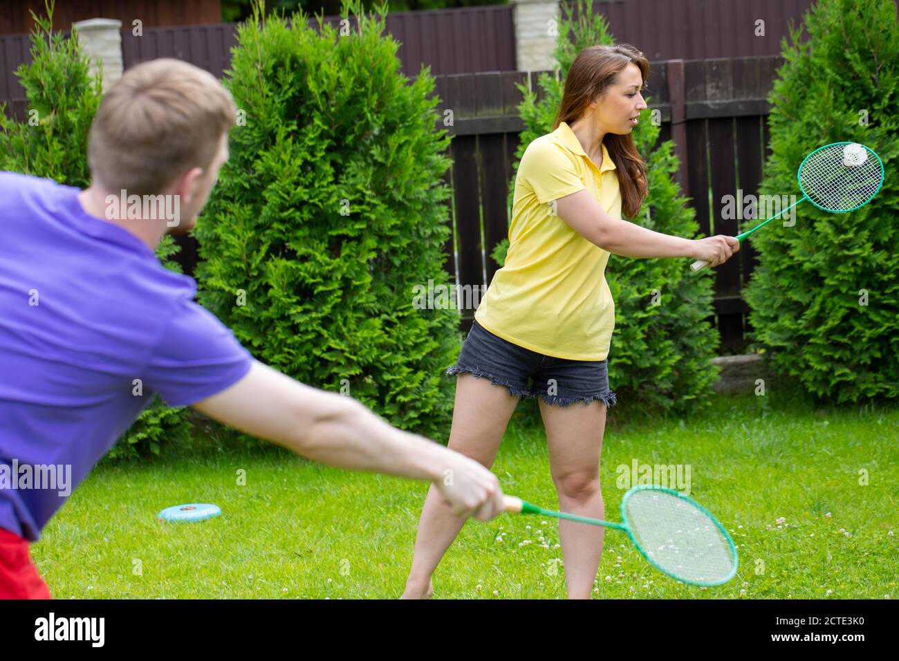 amateur game of badminton on green background. concept of outdoor activities  Stock Photo - Alamy