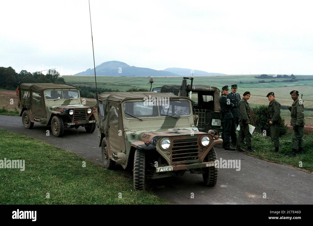 1979 - Members of the 11th Armored Cavalry stop to talk with West German soldiers while patrolling the border between East and West Germany in M151 light vehicles. Stock Photo