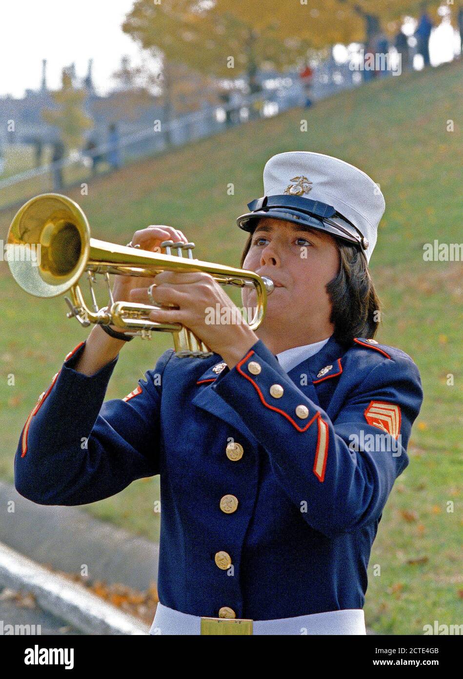 1979 - A woman Marine sergeant, who is a member of the band blows her trumpet, during a Marine Corps Birthday Pageant held in the stadium. Stock Photo