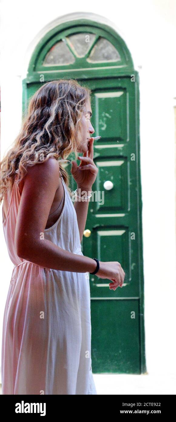 A woman smoking cigarette. Stock Photo