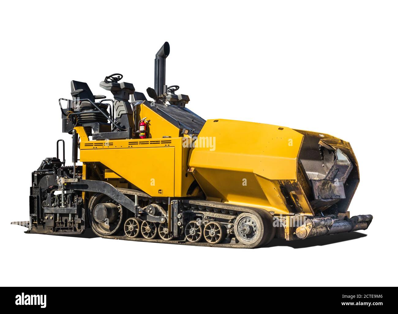 Large asphalt paving machine. Yellow road construction vehicle, with exposed drivers seat. Rubber truck paver. Isolated on white. Stock Photo