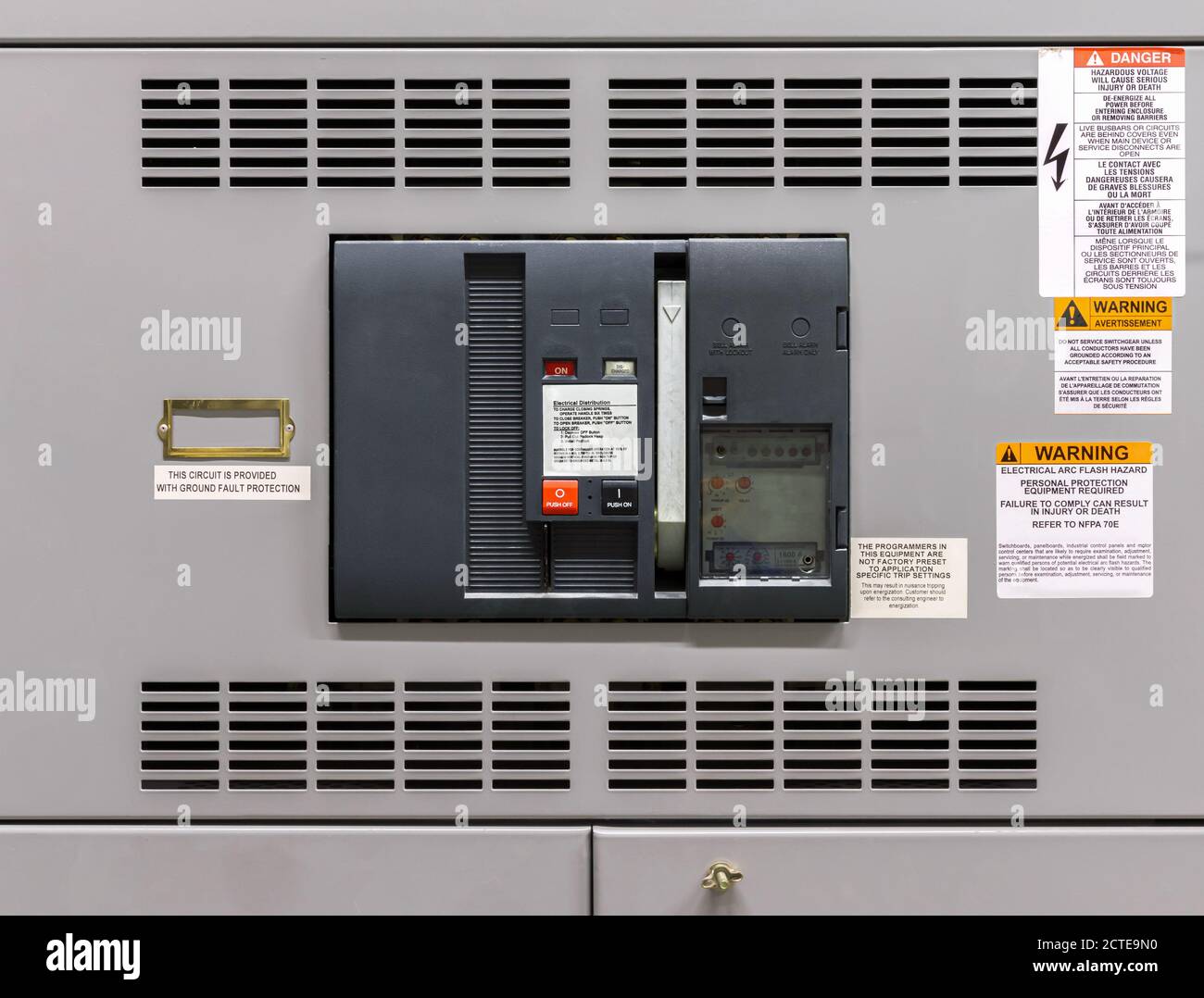 Main power breaker in electrical room of residential or commercial building. Insulated case circuit breaker with pump handle and bell. Stock Photo