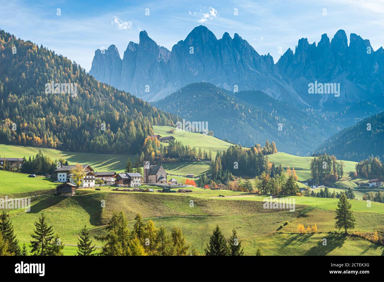 Landscape of early autumn on the church Santa Magdalena in northern Italy on the slopes of the Dolomites in the valley of Val di Funes. Stock Photo