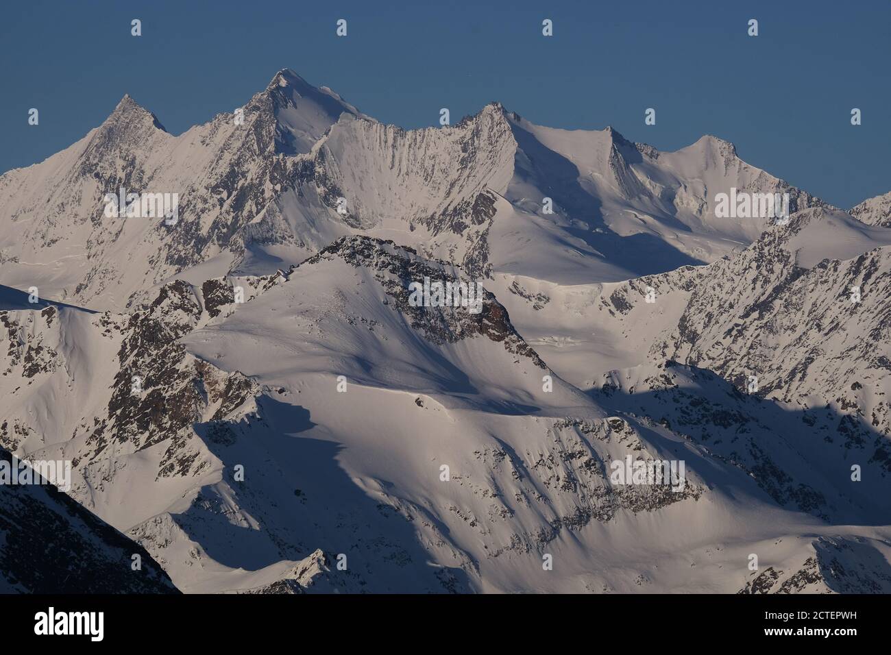 Snow covered summits of the Mischabel mountain range in the Swiss Alps in wintertime Stock Photo