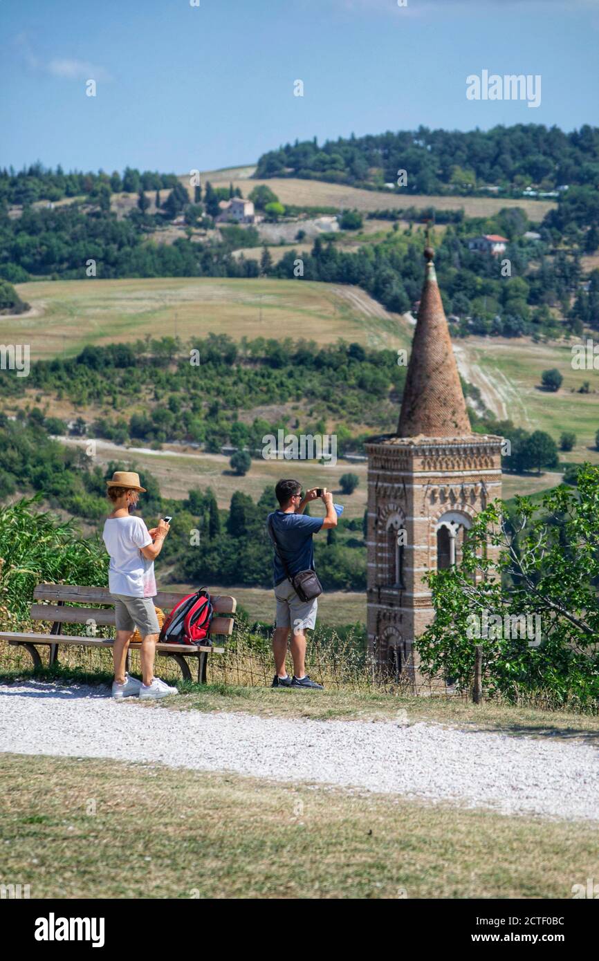 tourists take photos in the upper part of the city. in the background an ancient bell tower Stock Photo
