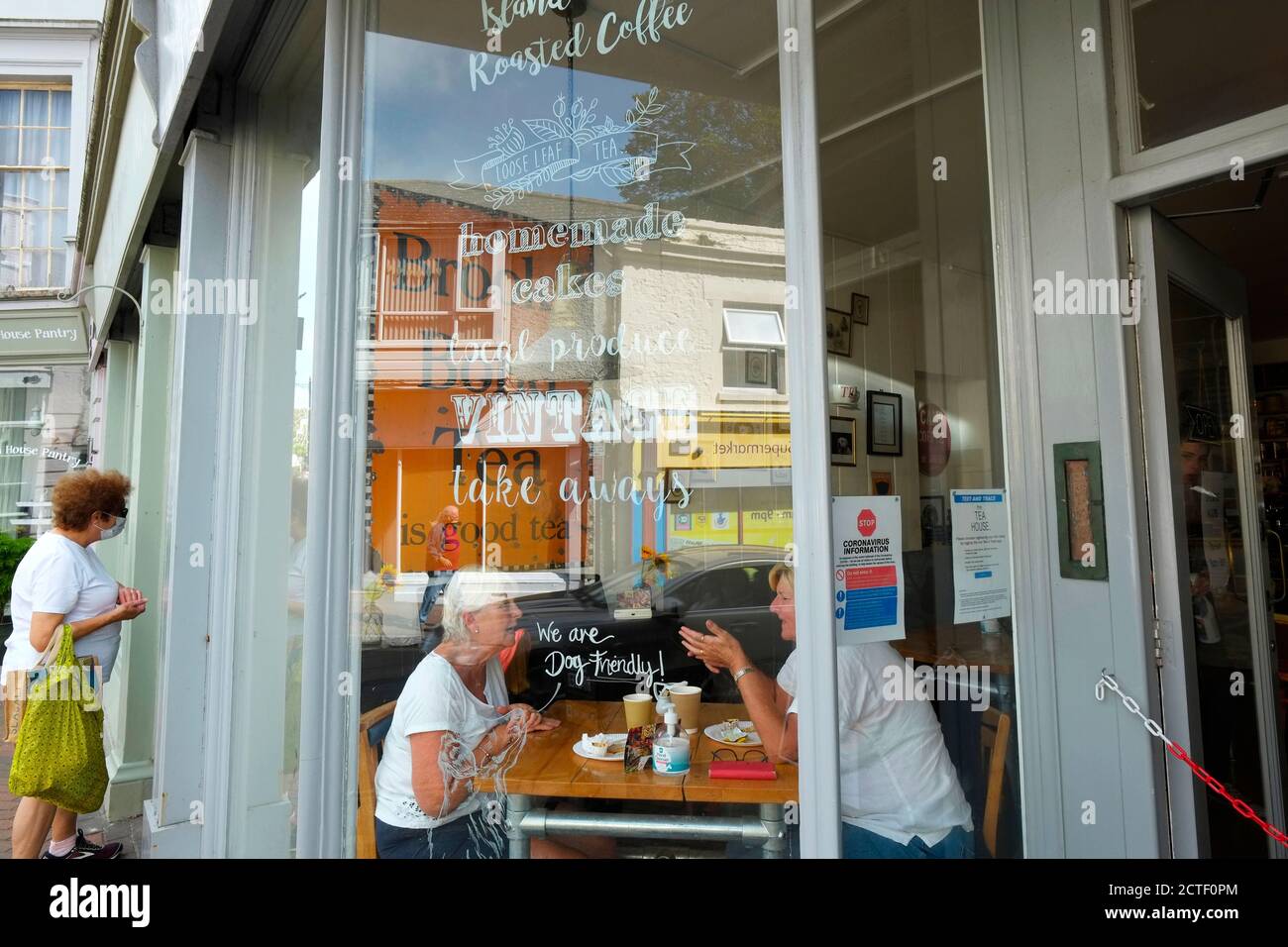 Ventnor Isle of Wight town cafe customers through window reflections on High Street Stock Photo
