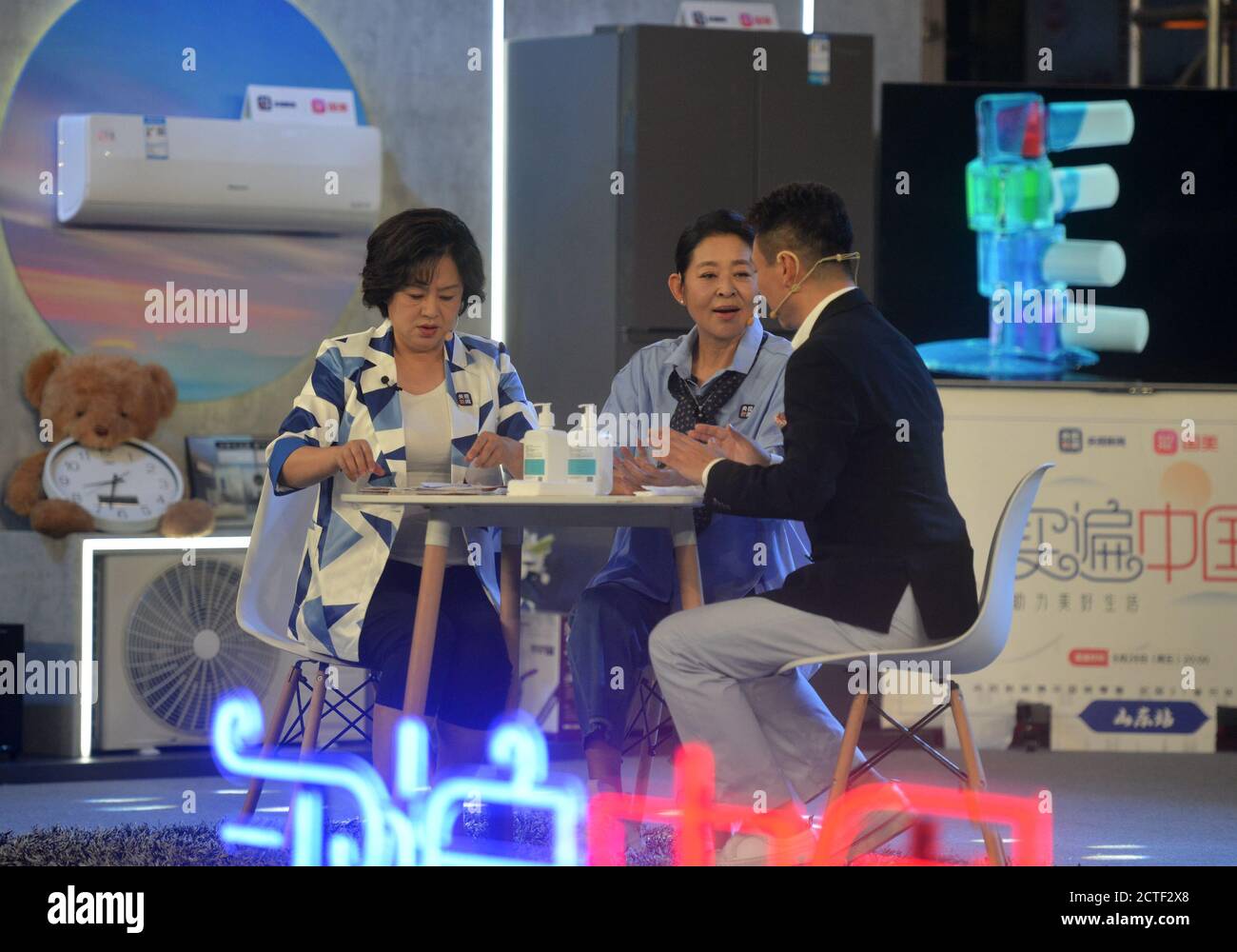 Chinese news anchor Kang Hui, right, Chinese film actress and TV host Ni Ping, middle, and Chinese child program host Ju Ping, left, together attend a Stock Photo